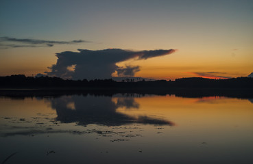 Fototapeta na wymiar Dark clouds over calm lake