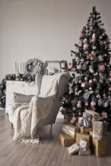 Christmas cozy place with a burning Christmas tree and white chair 9313.