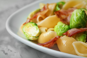 Plate of pasta with Brussels sprouts and bacon, closeup