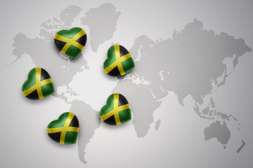 five hearts with national flag of jamaica on a world map background