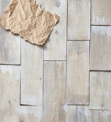 empty, crumpled paper on a wooden floor in the background