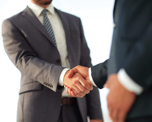 Friendly smiling businessmen handshaking. Business concept photo