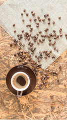 Βrown Coffee cup. Greek coffee on wooden background. Turkish coffee and beans.