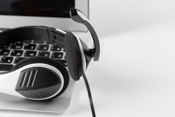 call center support concept. headset on keyboard computer laptop
