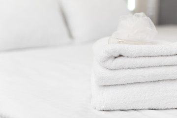 Fototapeta na wymiar Clean towels on bed at hotel room