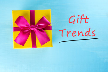 Gift trends. Thinking about new year, Christmas and valentine day gifts and online shopping. Red box present with bow