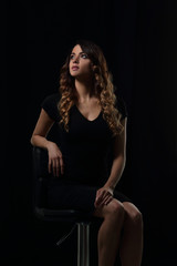 Studio shoot of beauty woman posing on the chair