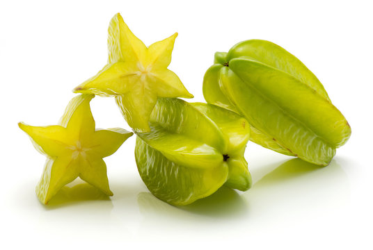 Two carambola and two halves isolated on white background.