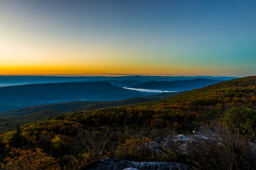 Morning dark sunrise with sky and golden yellow orange autumn foliage in Dolly Sods, Bear Rocks, West Virginia with overlook of mountain valley