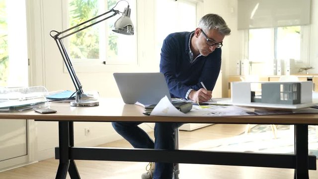 Architect in office working on construction project