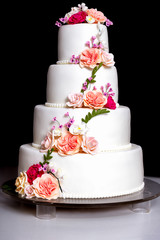 Creative wedding cake with colourful flowers design