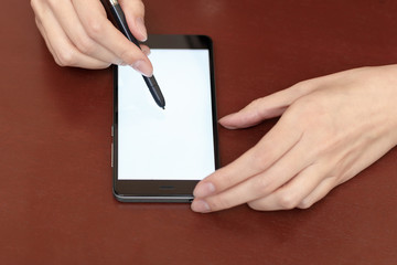 The girl behind the Desk with a smartphone and stylus.