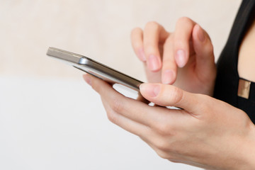 A young girl is holding smartphone.