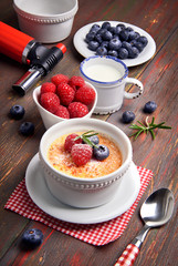Creme brulee with berries and vanilla stick, closeup