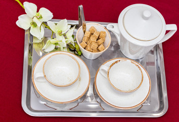 Two white mugs on a tray white bed, breakfast concept