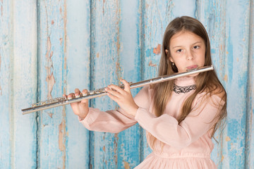Girl musician performing playing flute