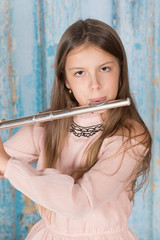 Young girl practising playing flute