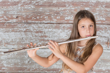 Girl musician performing playing flute