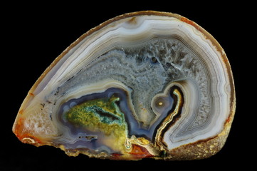 A cross section of the agate stone. Multicolored silica bands colored with metal oxides are...