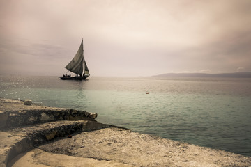 A sailboat in the distance off the coast of Haiti