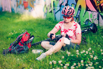 Woman dressing the wound on her knee