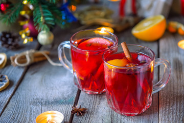 Christmas mulled wine, Hot winter drink with berries, orange,spices, cinnamon in glass cups on the...