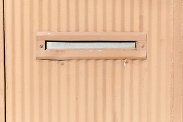 Old letterbox or mailbox in the metal gate door traditional way of delivering letters to the house close up