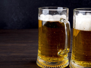 Glass of beer on wooden table with copyspace