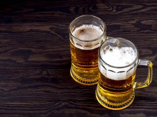 Glass of beer on wooden table with copyspace