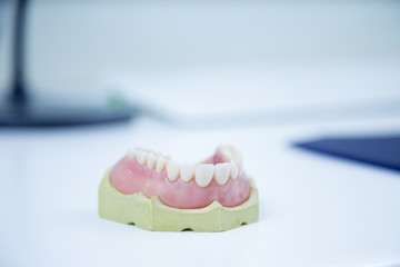 Fototapeta na wymiar Dental prosthesis on white table