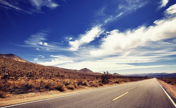 Vintage stylized picture of a Death Valley deserted road, travel concept, USA.