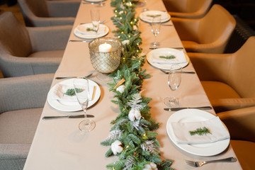 Christmas dinner feast. A decorated dining table with champagne glasses and christmas tree in background