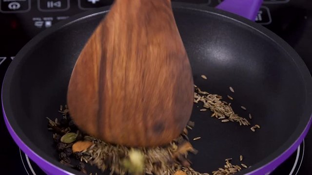 Indian Spices Dry Frying in a Hot Pan -  Closeup Shot