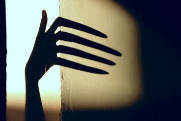 Black Shadow Of A Big Hand On The Wall. Silhouette Of A Hand On The Wall. Nightmares in Children. ...