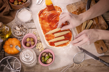 Woman makes vegetarian pizza. Vegetarian dish. Meatless food. Mediterranean cuisine. Selective focus. Easy toning