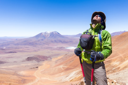 Tourist man adventurer backpacker standing mountain peak, Bolivia.