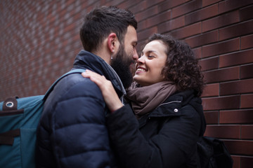 A kiss on the city street. Young couple in love, Valentine's Day.