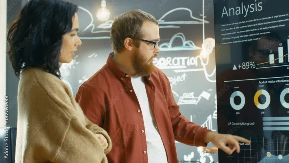 Poster Female Developer and Male Statistician Use Interactive Whiteboard Presentation Touchscreen to Look at Charts, Graphs and Growth Statistics. Shot on RED EPIC-W 8K Helium Cinema Camera.