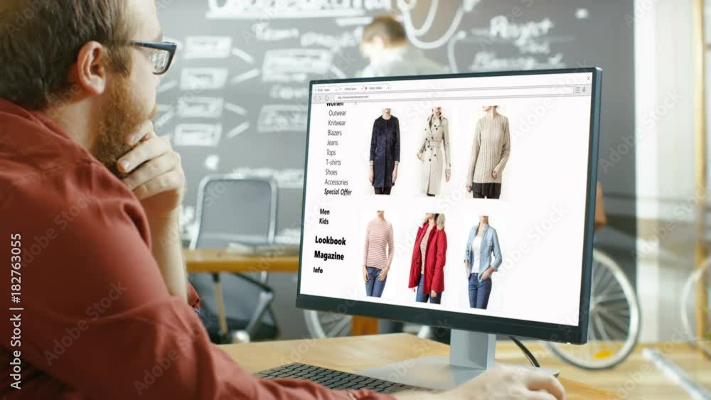 Poster web designer works on a website for online retail clothing store. he and colleagues work in stylish 