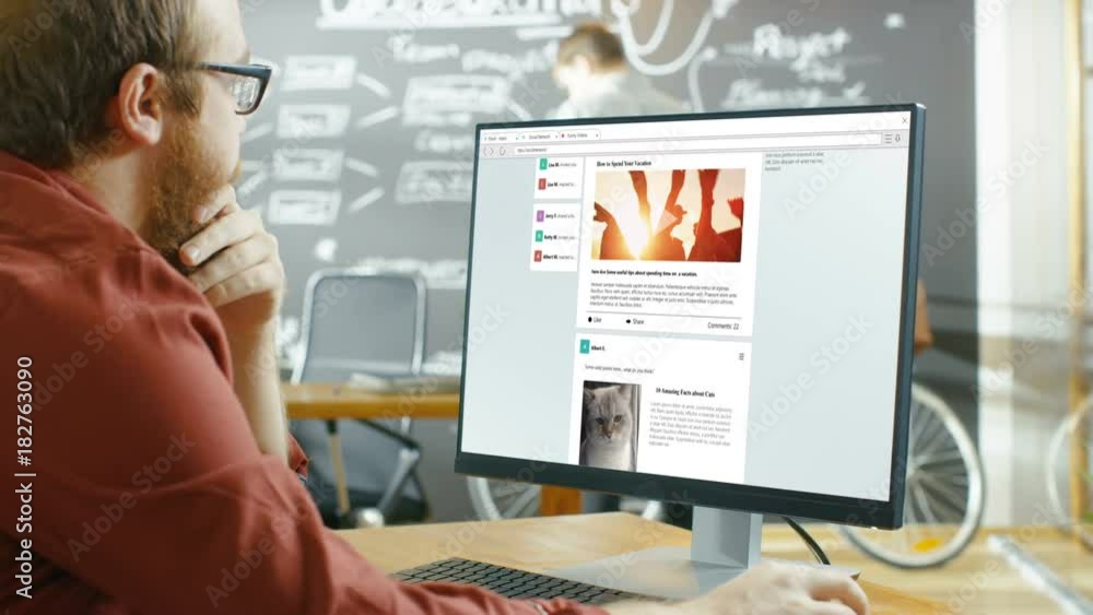 Poster creative office worker browsing social network pages, he scrolls through his wall on a personal comp