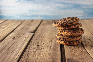Chocolate chip cookies on dark old wooden table. Mockup with place for text. Toned