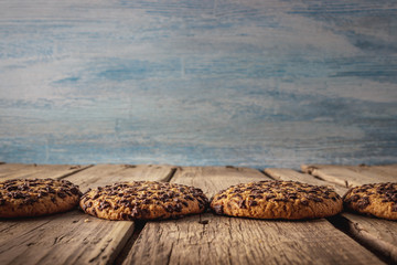 Chocolate chip cookies on dark old wooden table. Mockup with place for text. Toned