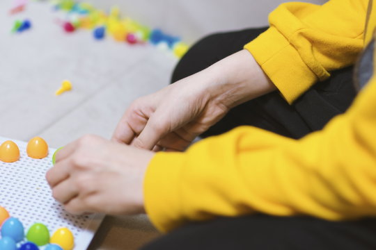 Kid playing pinning board game