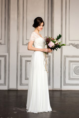Fototapeta premium Wedding fashion bride with bouquet in hands