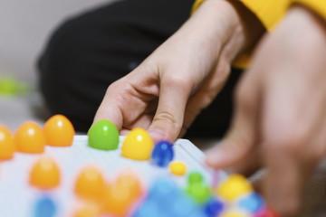 Kid playing pinning board game