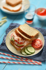 sandwich with roast turkey, cucumbers and tomato