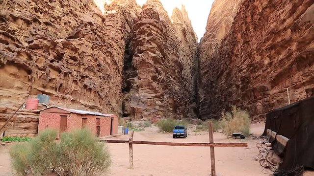 Two cabins and blue car in mountains, Wadi Rum desert, also known as The Valley of Moon in Hashemite Kingdom of Jordan