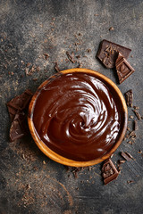 Chocolate ganache in a wooden bowl .Top view with copy space.