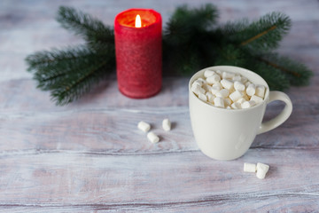 Obraz na płótnie Canvas Marshmallows in a cup on a wooden table. Christmas background. Selective focus. Copy space.