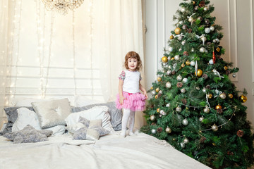 Obraz na płótnie Canvas young girl near a Christmas tree